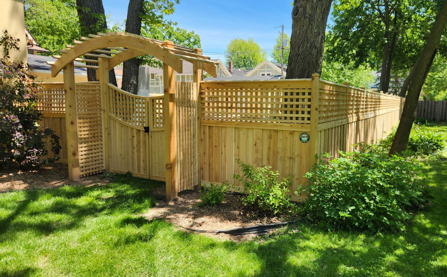 Custom wooden fence with decorative lattice top and arched gate - Fort Mill, SC
