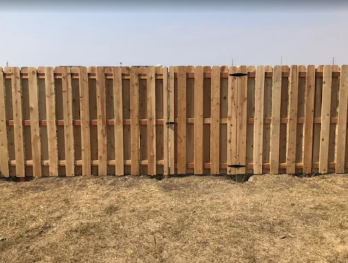 Shadowbox wooden fence design with alternating boards - Gastonia, NC